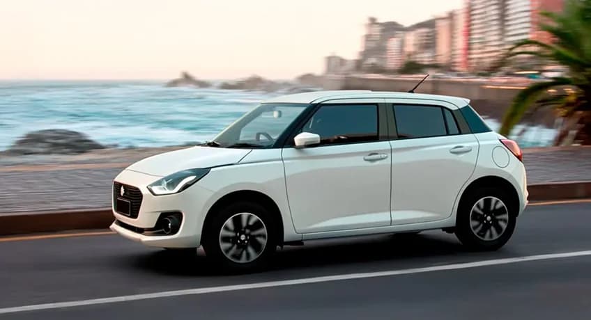 2025 Suzuki Swift driving along a coastal road