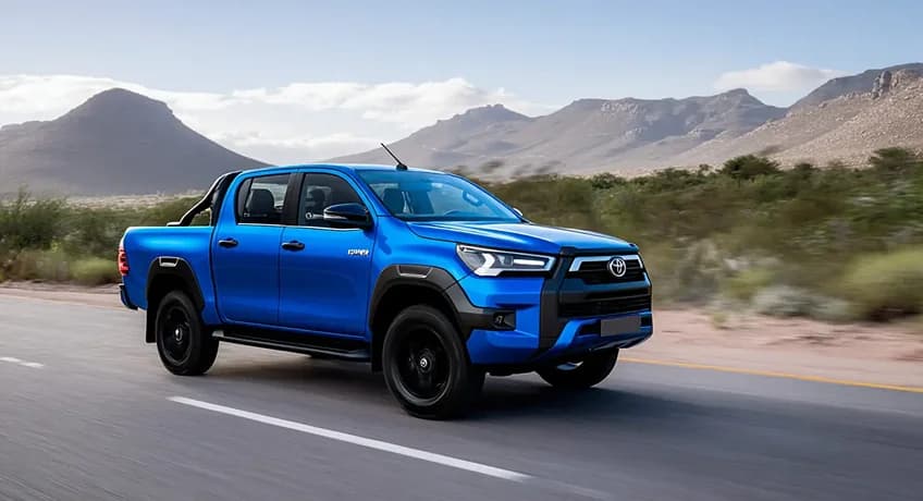 2025 Toyota Hilux driving on a mountain road